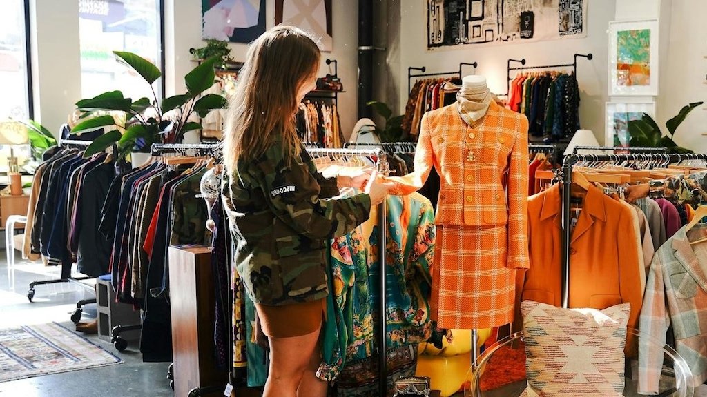 Trying out your brand with a sprinkle of local charm and market vibes Tiny fashion brand stall at the local marketplace adorned with handcrafted signs